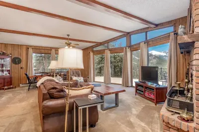a living room with a couch and a table at Macmillan Home in Estes Park