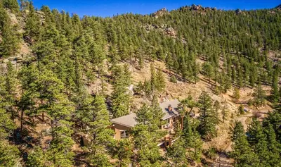 an aerial view of a house on the side of a mountain at Cedar Lower Condominium 2 Bedroom condo in Estes Park