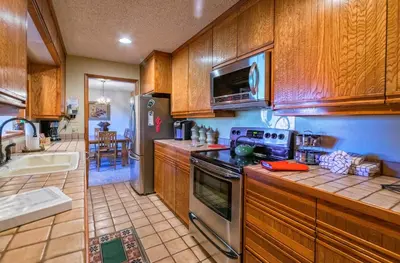 a kitchen with wooden cabinets and a stove top oven at Cedar Lower Condominium 2 Bedroom condo in Estes Park