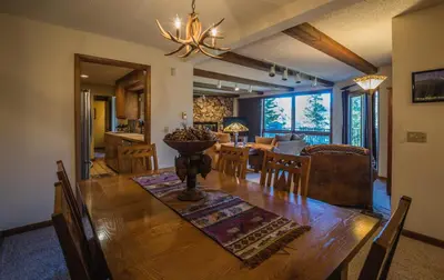 a dining room and living room with a table and chairs at Cedar Lower Condominium 2 Bedroom condo in Estes Park