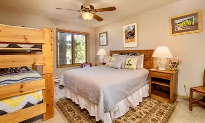 a bedroom with a bed and a bunk bed at Jordan Condominium 3 Bedroom condo in Estes Park