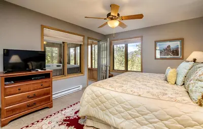 a bedroom with a bed and a flat screen tv at Jordan Condominium 3 Bedroom condo in Estes Park