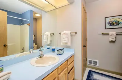 a bathroom with a sink and a mirror at Jordan Condominium 3 Bedroom condo in Estes Park