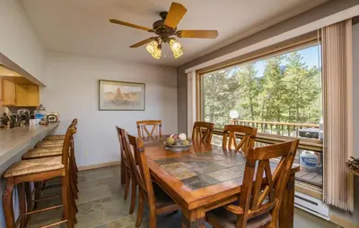 a dining room with a table and chairs and a window at Jordan Condominium 3 Bedroom condo in Estes Park
