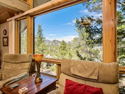a room with a table and two chairs and a large window at Jordan Condominium 3 Bedroom condo in Estes Park