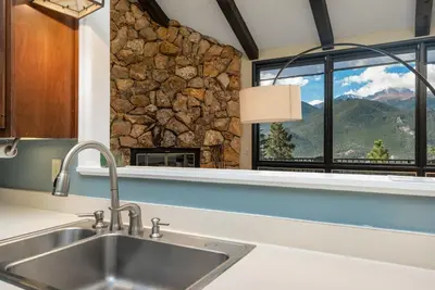 a kitchen with a sink and a window with a mountain view at Cedar Upper Condominium 3 Bedroom condo in Estes Park