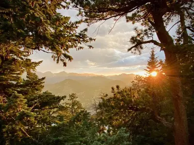 a view of the mountains through the trees at Cedar Upper Condominium 3 Bedroom condo in Estes Park