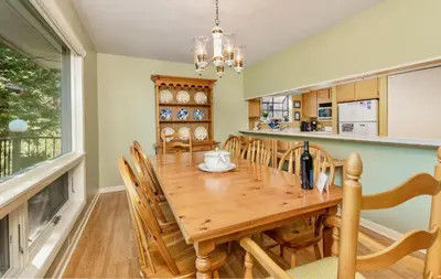 a dining room with a wooden table and chairs at Werlein Condominium 4 Bedroom condo in Estes Park