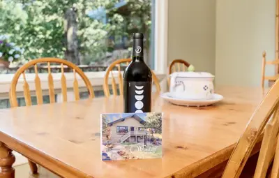 a bottle of wine sitting on top of a wooden table at Werlein Condominium 4 Bedroom condo in Estes Park