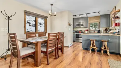 a kitchen with a dining room table and chairs at Stevenson Home in Estes Park