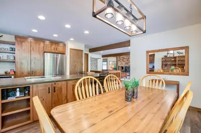 a kitchen with a wooden table and chairs at Griffin Family Condominium 4 Bedroom condo in Estes Park