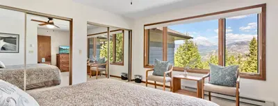 a bedroom with two beds and a large window at Griffin Family Condominium 4 Bedroom condo in Estes Park