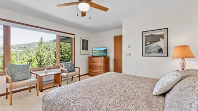 a bedroom with a bed and a large window at Griffin Family Condominium 4 Bedroom condo in Estes Park
