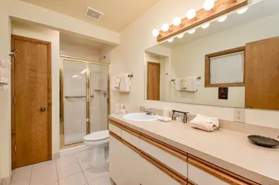 a bathroom with a sink and a toilet and a mirror at Griffin Family Condominium 4 Bedroom condo in Estes Park