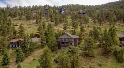 an aerial view of a house on a hill with trees at Alleman North Condominium 3 Bedroom condo in Estes Park