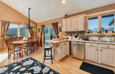 a kitchen and dining room with a table and chairs at Awestruck Home in Estes Park