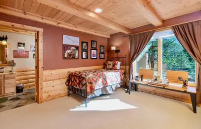 a bedroom with a bed and a window at Awestruck Home in Estes Park