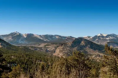 a view of a mountain range with snow covered mountains at Awestruck Home in Estes Park