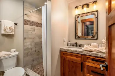 a bathroom with a toilet sink and a mirror at Breiding Upper Condominium 2 Bedroom condo in Estes Park