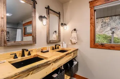 a bathroom with two sinks and a large mirror at Breiding Upper Condominium 2 Bedroom condo in Estes Park
