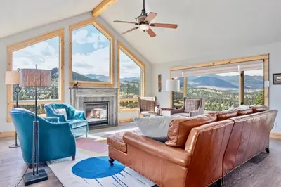 a living room with a couch and a fireplace at Mapes Home in Estes Park