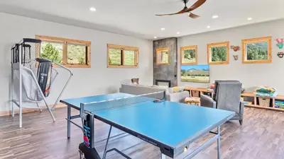 a living room with a ping pong table at Mapes Home in Estes Park