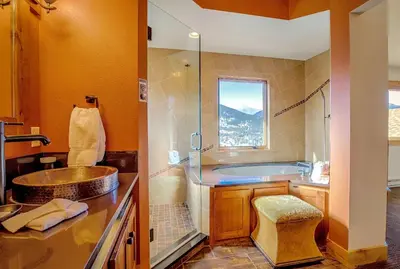 a bathroom with a tub and a sink and a shower at Mapes Home in Estes Park