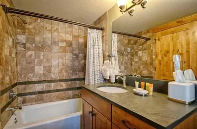 a bathroom with a sink and a bath tub at Mapes Home in Estes Park