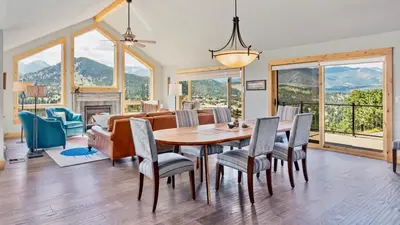 a dining room with a table and chairs at Mapes Home in Estes Park