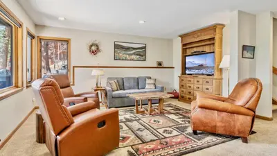 a living room with leather furniture and a flat screen tv at Dances With Wolves Condominium 3 Bedroom condo in Estes Park