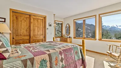 a bedroom with a bed with a view of mountains at Dances With Wolves Condominium 3 Bedroom condo in Estes Park