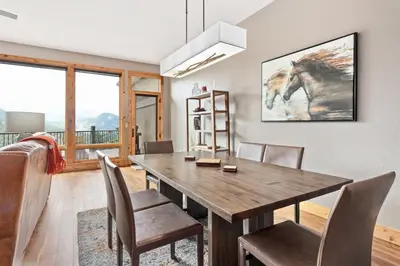 a dining room with a wooden table and chairs at Serenity Condominium 3 Bedroom condo in Estes Park