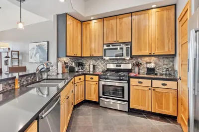 a kitchen with wooden cabinets and stainless steel appliances at Serenity Condominium 3 Bedroom condo in Estes Park