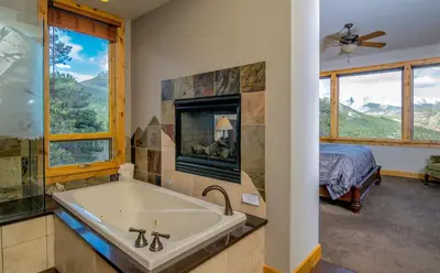 a bathroom with a tub and a bedroom with a bed at Serenity Condominium 3 Bedroom condo in Estes Park