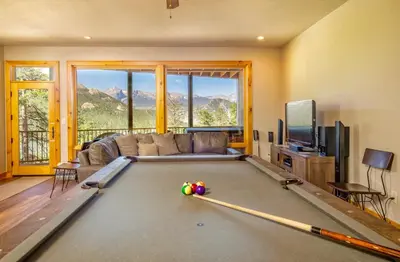a living room with a pool table with a couch at Serenity Condominium 3 Bedroom condo in Estes Park