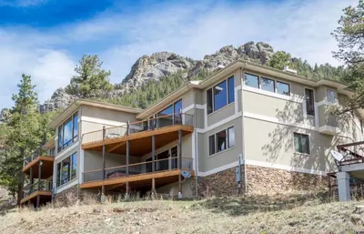 an apartment building with a mountain in the background at Serenity Condominium 3 Bedroom condo in Estes Park