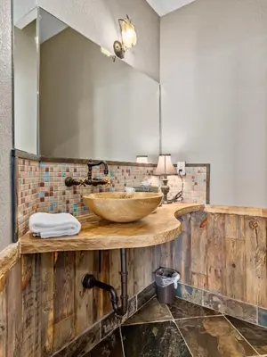 a bathroom with a wooden counter with a sink at Garlands' Alpine Lodge Condominium 3 Bedroom condo in Estes Park