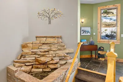 a stone staircase in a home with a stack of rocks at Garlands' Alpine Lodge Condominium 3 Bedroom condo in Estes Park