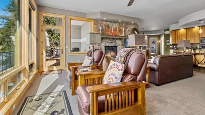 a living room with chairs and a fireplace at Garlands' Alpine Lodge Condominium 3 Bedroom condo in Estes Park