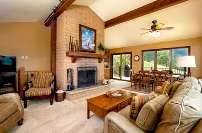 a living room with a couch and a fireplace at Kintzle Home in Estes Park