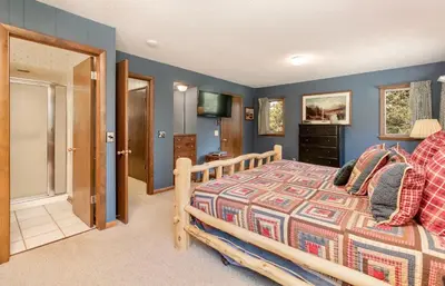 a bedroom with a wooden bed in a room at Salmans Bear Cove Home in Estes Park