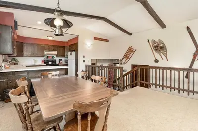 a kitchen and dining room with a wooden table at Salmans Bear Cove Home in Estes Park
