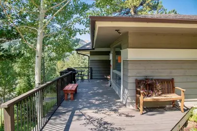 a porch of a house with a bench on it at Adams Condominium 2 Bedroom condo in Estes Park