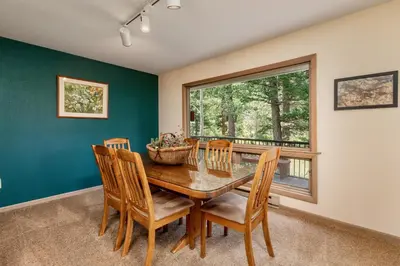 a dining room with a table and chairs and a window at Adams Condominium 2 Bedroom condo in Estes Park