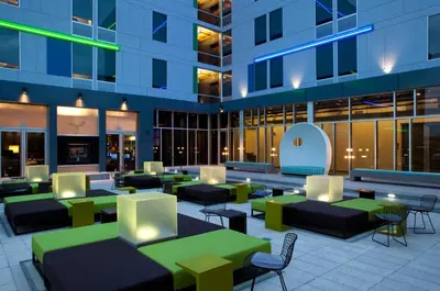 a lobby of a building with tables and chairs at Aloft Denver Airport at Gateway Park in Aurora