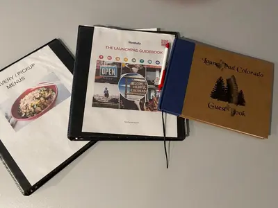three books sitting on top of a table at Launch Pad 2 Denver, Boulder & Mountains in Lafayette