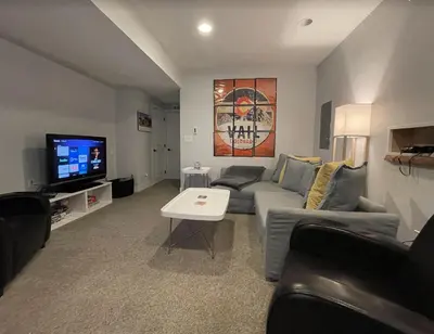 a living room with a couch and a tv at Launch Pad 2 Denver, Boulder & Mountains in Lafayette