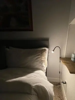 a bed with white sheets and a lamp in a room at Launch Pad 2 Denver, Boulder & Mountains in Lafayette