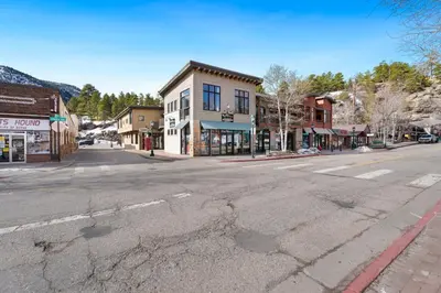 an empty street in a small town with an empty street at Spacious Dtwn Estes Park Loft Condo 4 Mi to RMNP in Estes Park
