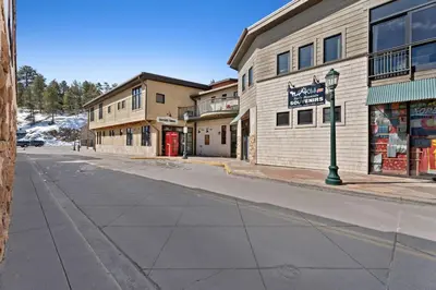an empty street in front of a building at Spacious Dtwn Estes Park Loft Condo 4 Mi to RMNP in Estes Park